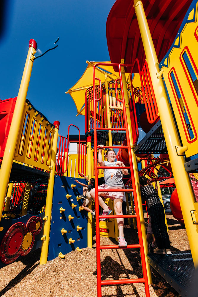 Girl climbing a ladder at a playground in a Burger King