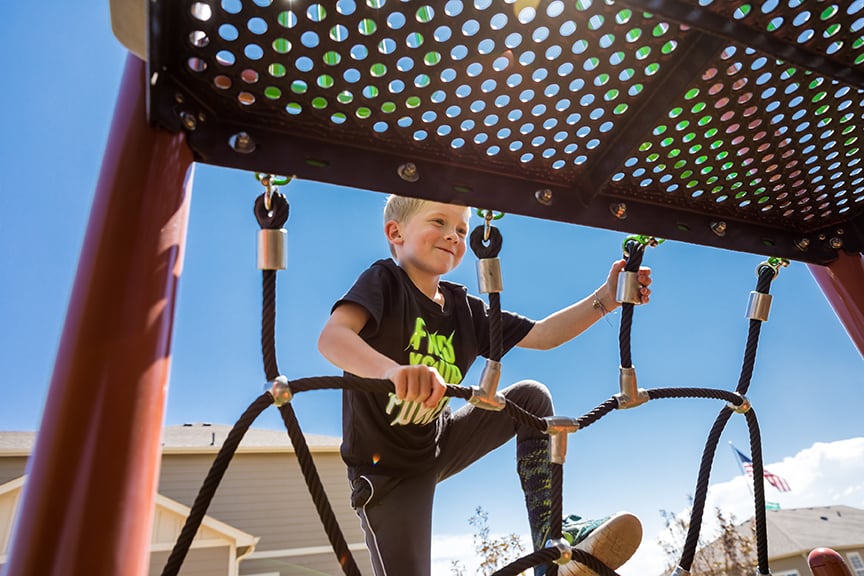 Young Child climbing on a playground.