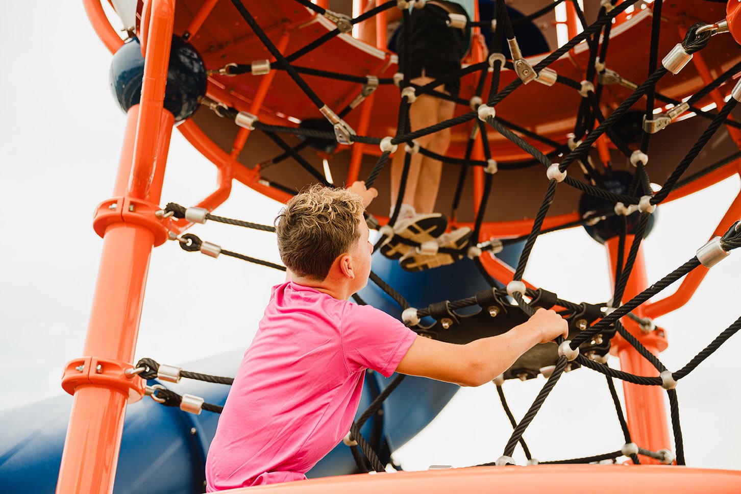 Children climbing on a commercial Ascend rope climber